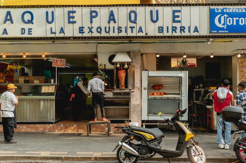 a group of people standing in front of a restaurant