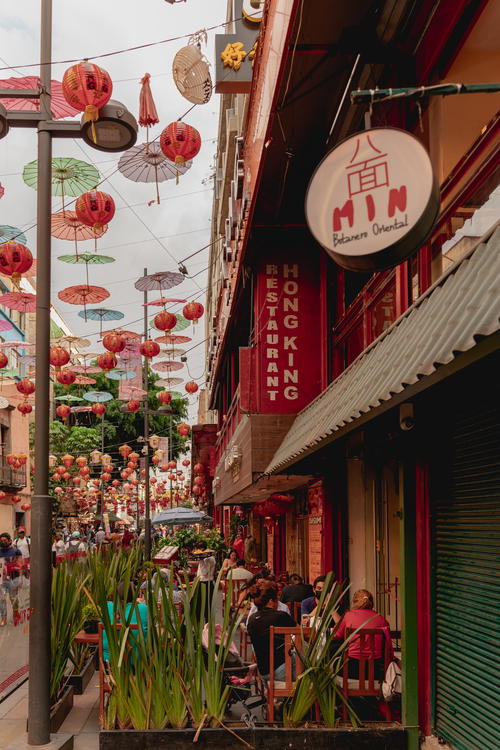 a group of people walking down a street with umbrellas