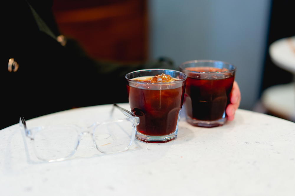 Two glasses of iced coffee from Chiquitito Cafe on a table in Mexico City.