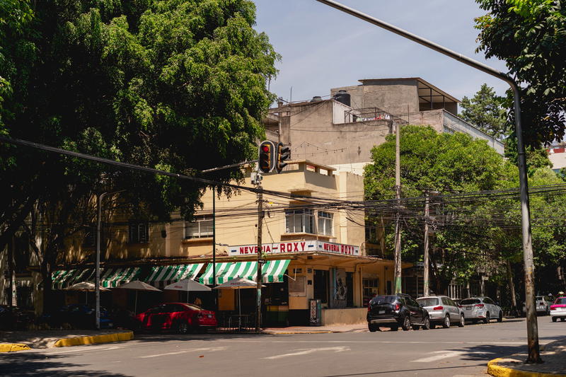 a street scene with a stop light on a pole