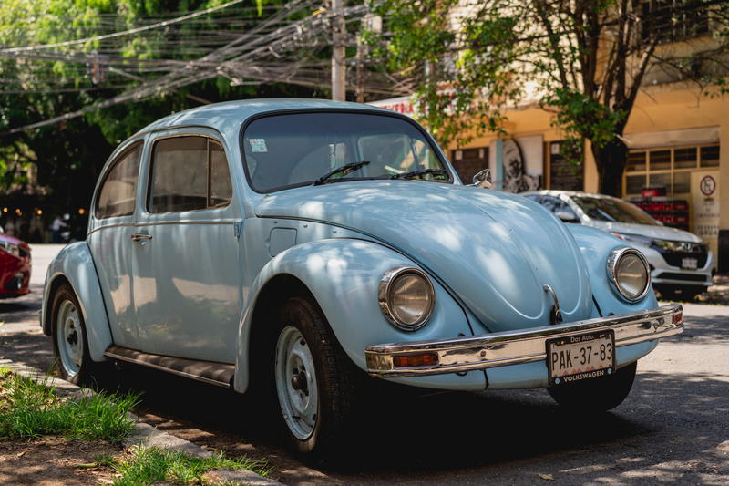 a blue car parked on the side of the road