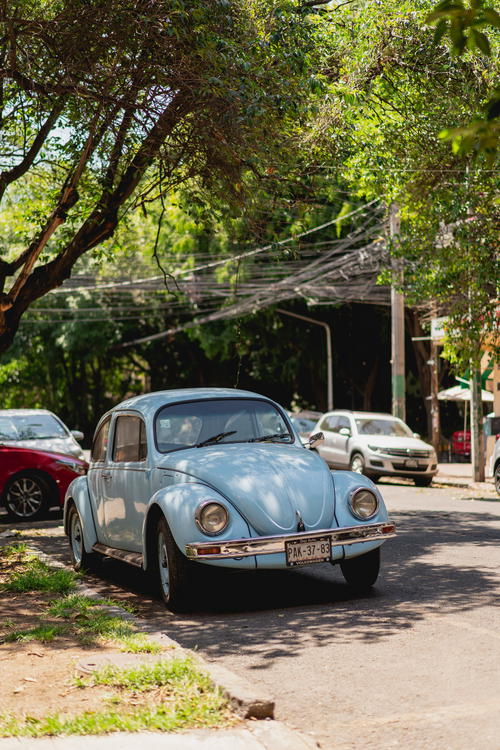 a blue car parked on the side of the road