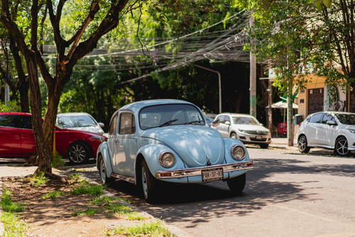 a blue car parked on the side of the road