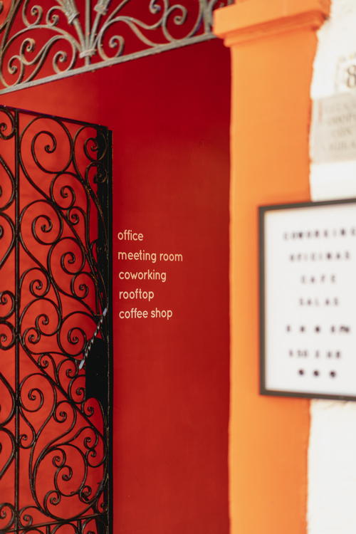 a red wall with a sign that says coffee