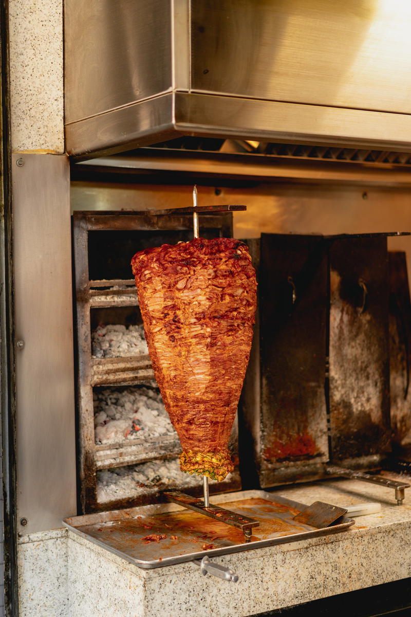 a large piece of meat is being cooked in an oven