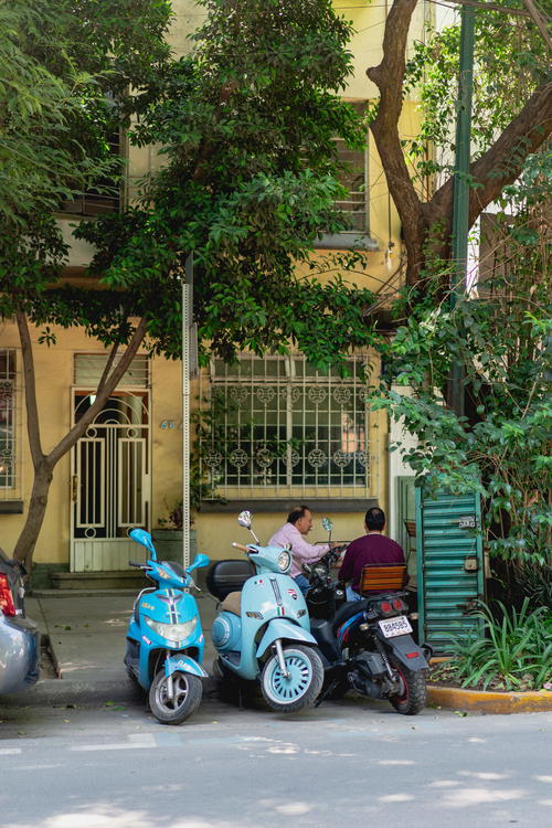 a couple of motor scoots parked in front of a building