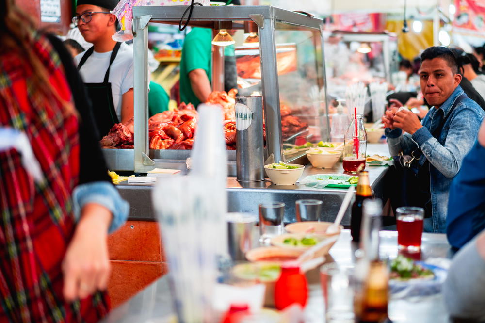 A group of people at a food stand in Mexico City.