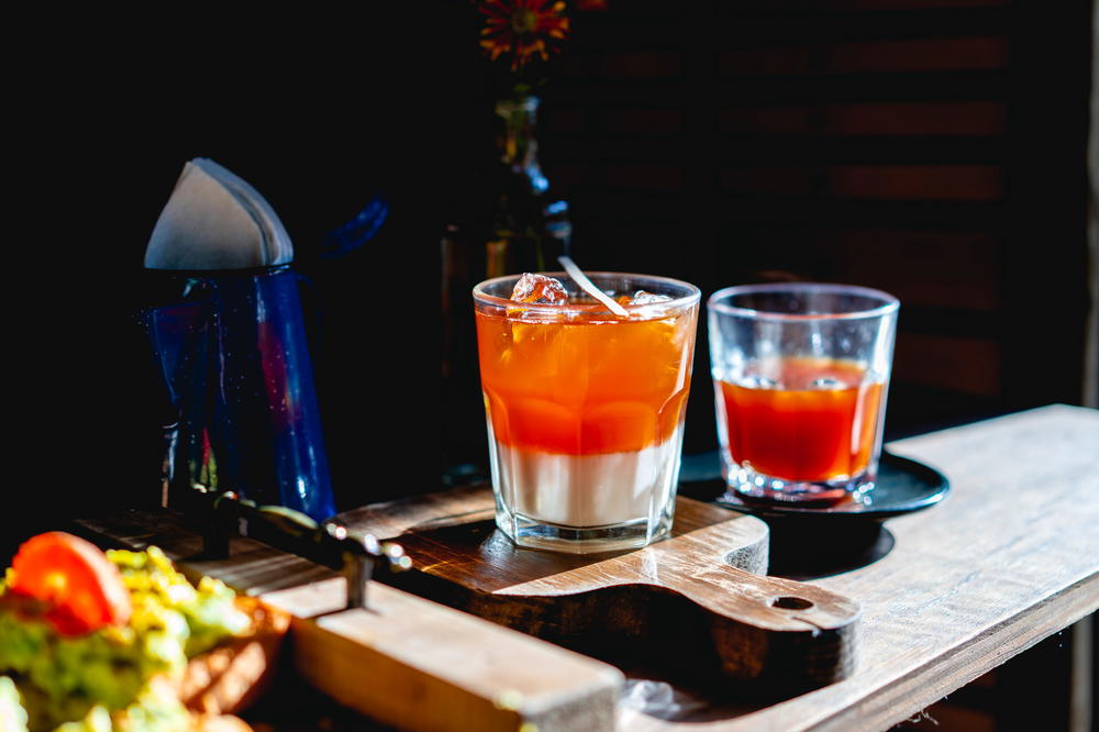 A drink is sitting on a wooden tray in Mexico City.