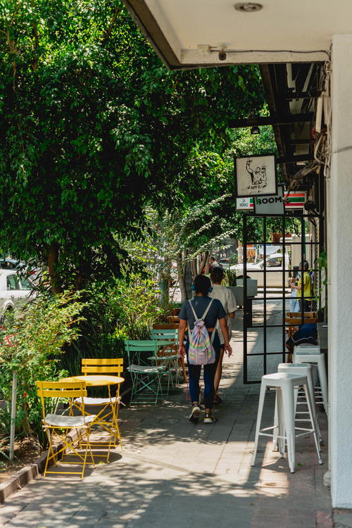 A sidewalk with tables and chairs in Mexico City.