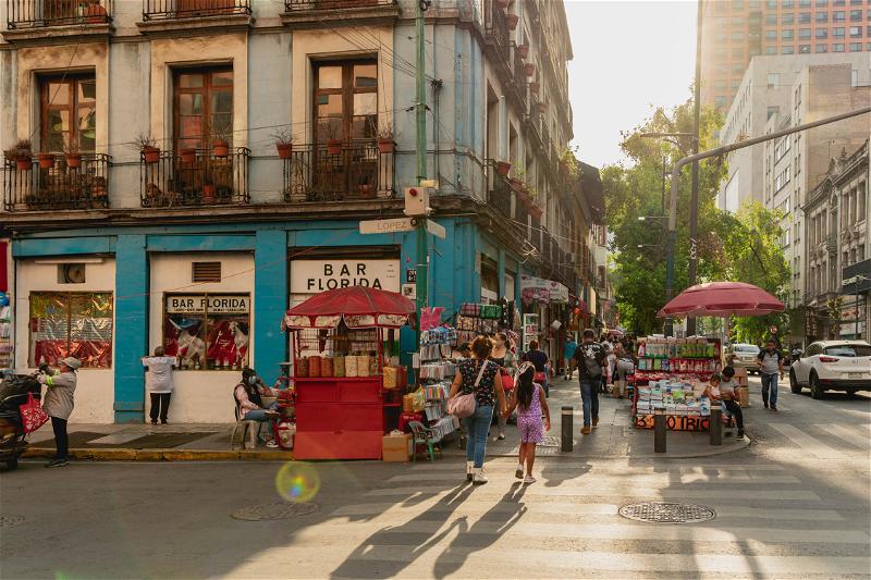 A bustling Mexico City street filled with numerous pedestrians.