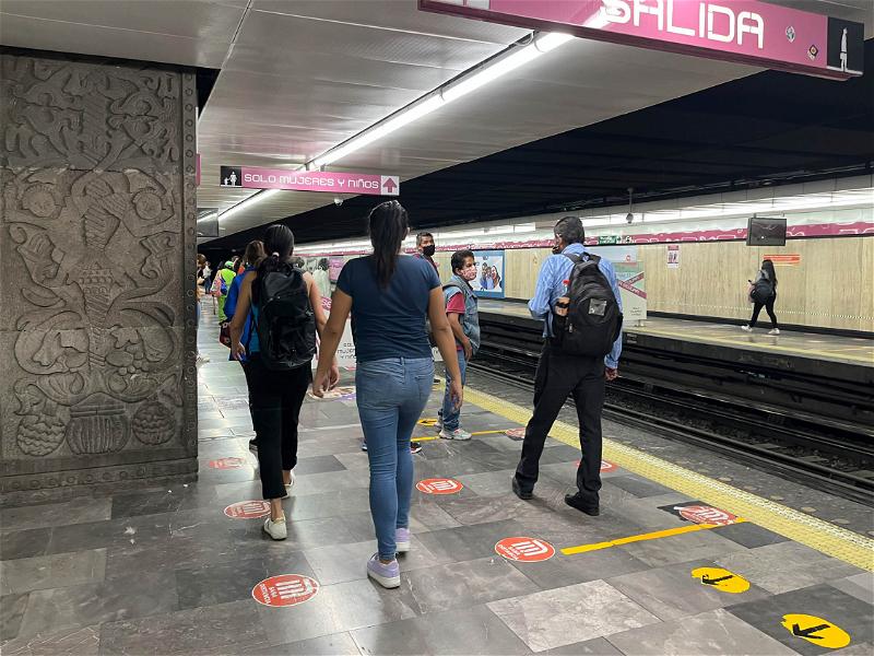 A group of people walking in a subway station in Mexico City.