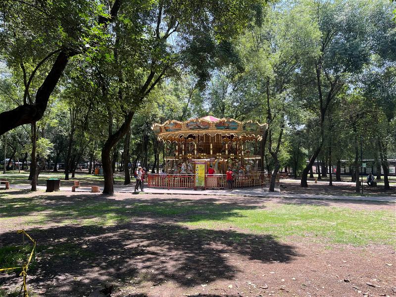 A tree-surrounded carousel in Mexico City.
