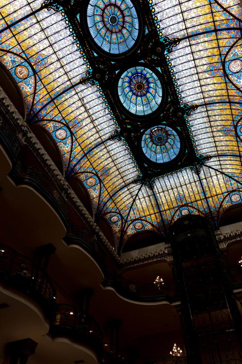 A stained glass ceiling in a building located in Mexico City.