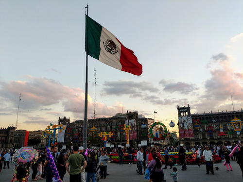 A Mexican flag is flying in a plaza in Mexico City.