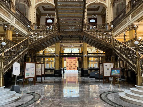 An ornate building with stairs and a staircase in Mexico City.