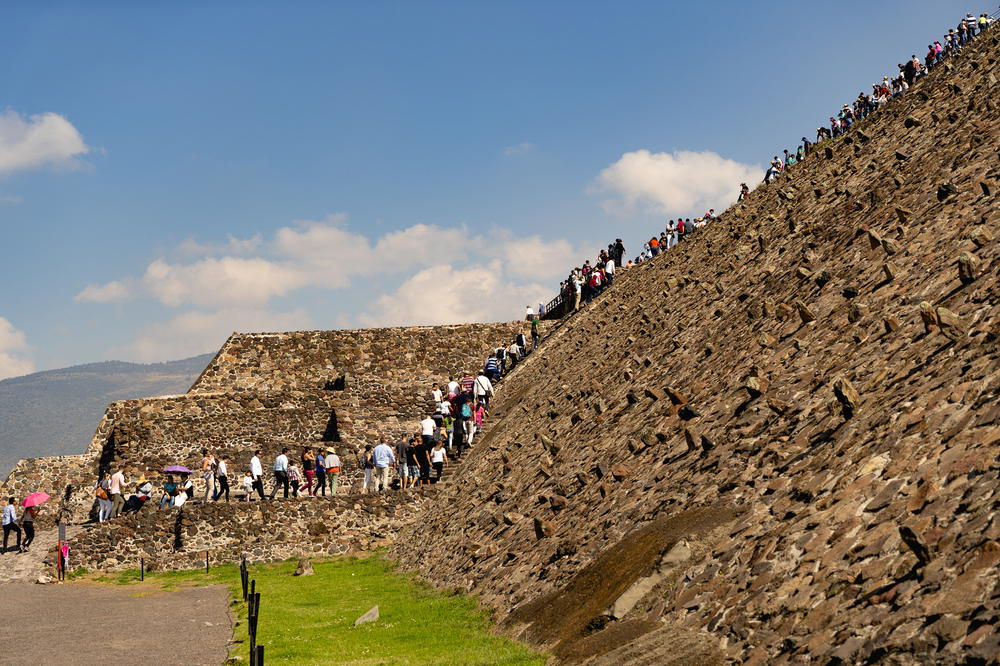 Line of tourists climbing Teotihuacan Ancient Pyramids Mexico