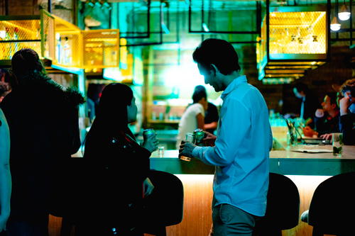 A group of people standing at a bar in Mexico City.