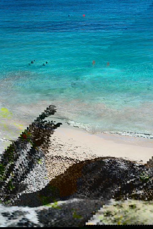 People swimming at the beach in the Tulum Ruins