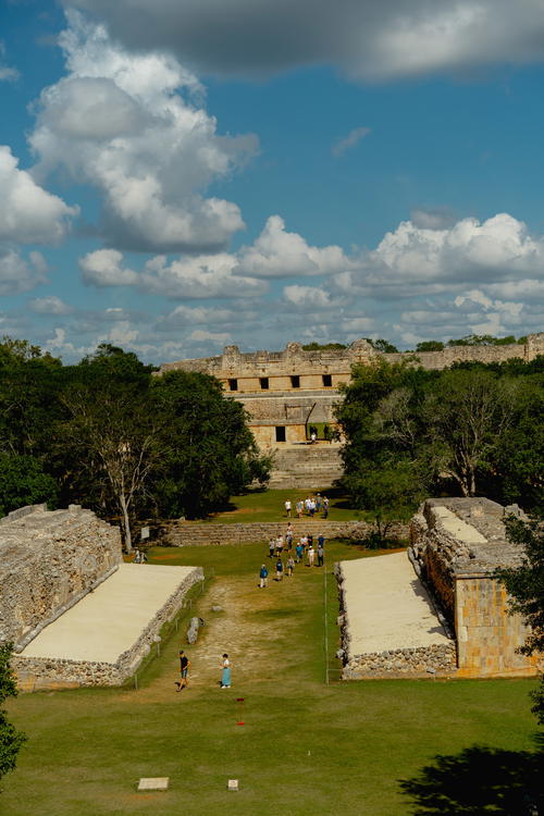 A group of people are playing a game of frisbee in Uxmal, Mexico.