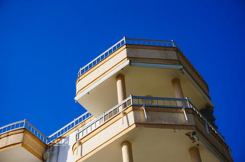 A tall building with balconies on top of it