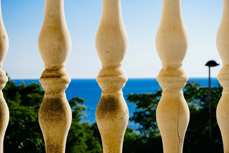 A view of the ocean from behind a fence