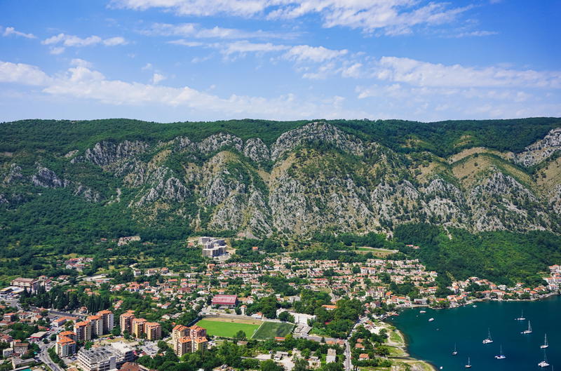 An aerial view of a city with mountains in the background in Budva