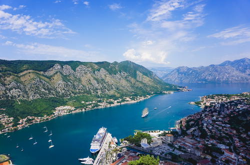 A large body of water surrounded by mountains in Budva