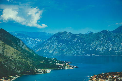 A scenic view of a lake surrounded by mountains in Budva