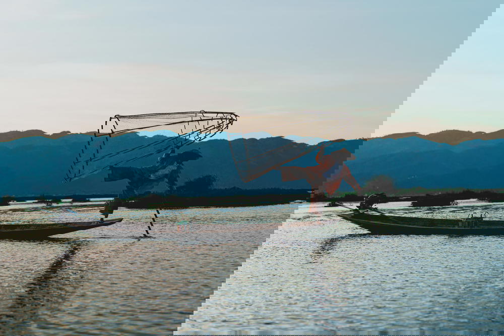 Dancing fishermen standing on one foot at Inle Lake Myanmar