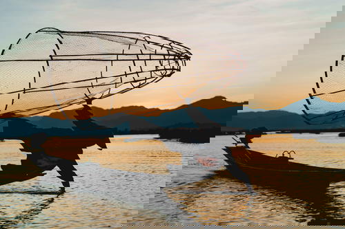 A man in a boat with a net in Myanmar (Burma).