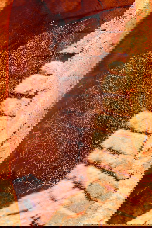 A spider web in a doorway of a sandstone building in Myanmar (Burma).