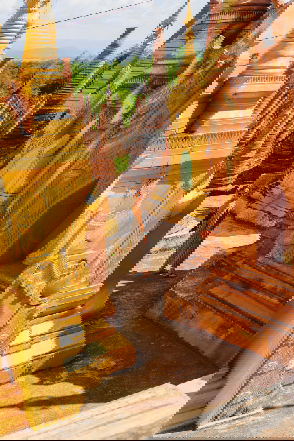 Girl in a dress among the golden stupas outside Indein Pagoda in Indein Myanmar