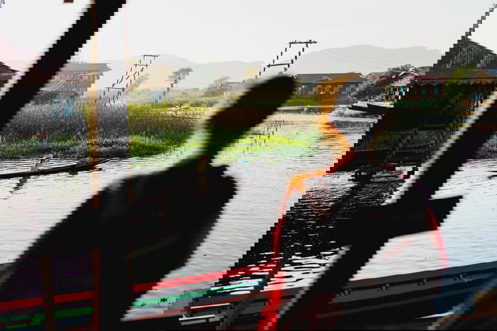 A woman admiring Inle Lake from a window.