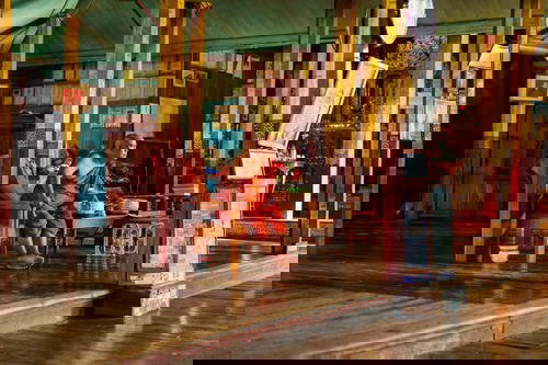 A man sitting on a bench at Inle Lake in Myanmar (Burma).