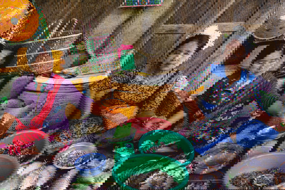 Burmese local Shan state women selling fresh fish and seafood at village market of Nyaungshwe Myanmar