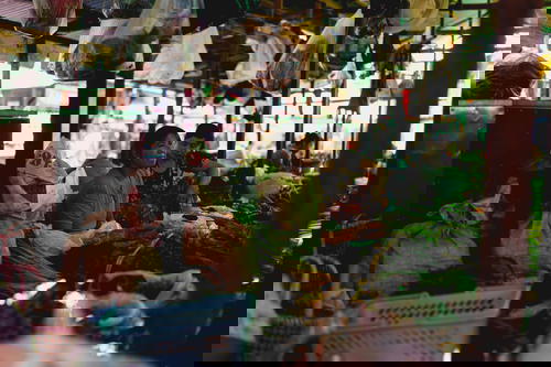 A group of people standing in the bustling market of Inle Lake, Myanmar (Burma).