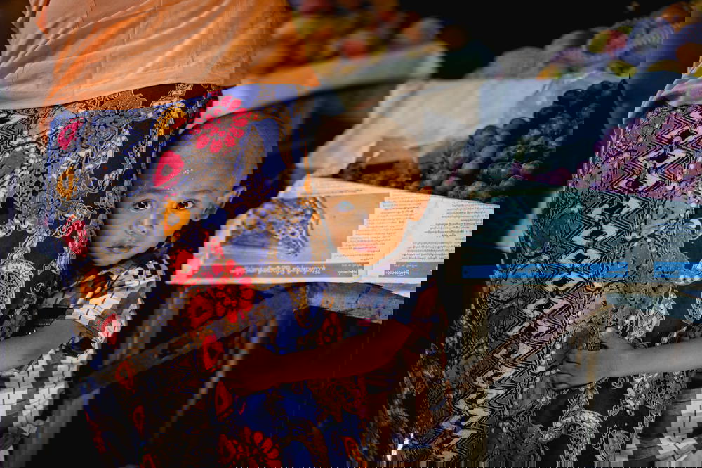 Little Burmese boys hugs his mother's legs in the village market of Nyaungshwe Myanmar