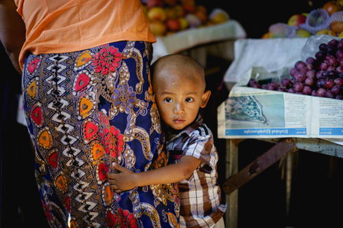 A woman with a child at an Inle Lake fruit stand in Myanmar (Burma).