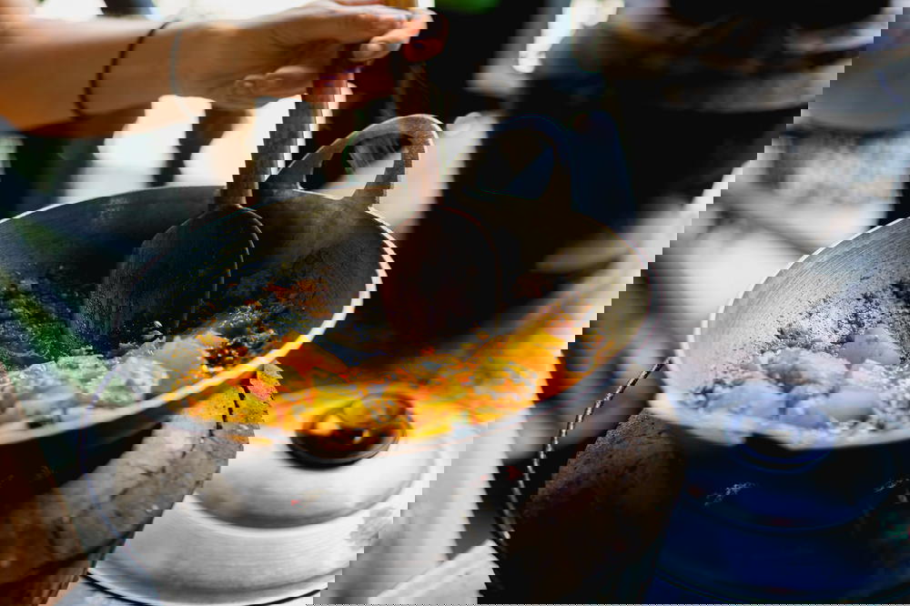 Travelers learning how to cook Burmese traditional potato curry in a cooking class at Nyaungshwe Myanmar