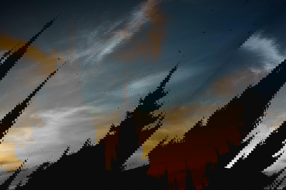 Spires of Buddhist shrines against a sunset sky in Yangon Myanmar at Shwedagon Pagoda