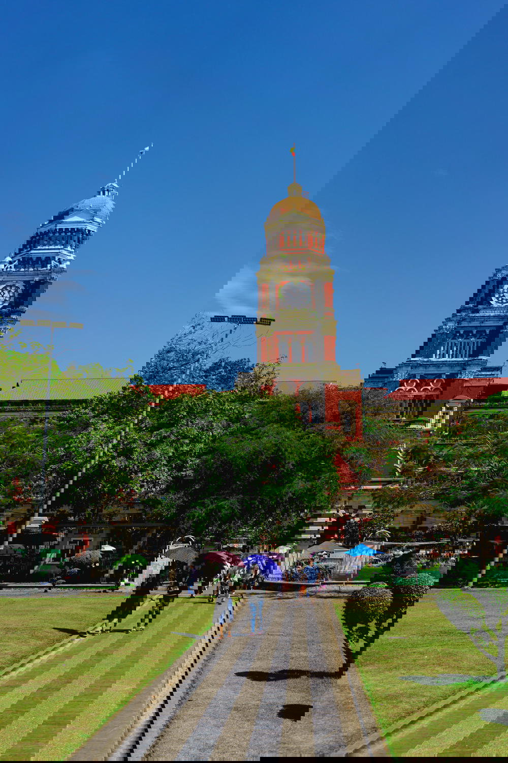 Historic British style red brick building at the end of a stone pathway in Chinatown of Yangon Myanmar