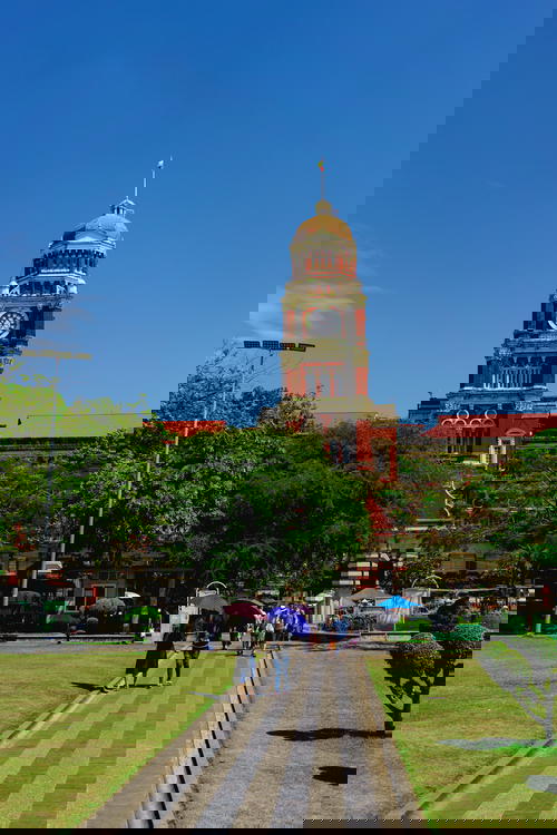 A brick building with a clock tower in Myanmar.