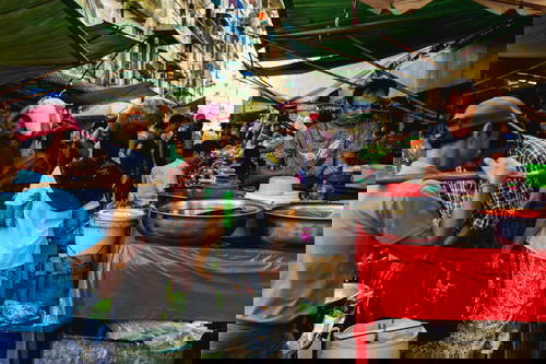 Street market local vendors selling goods and produce in Chinatown Yangon Myanmar Burma