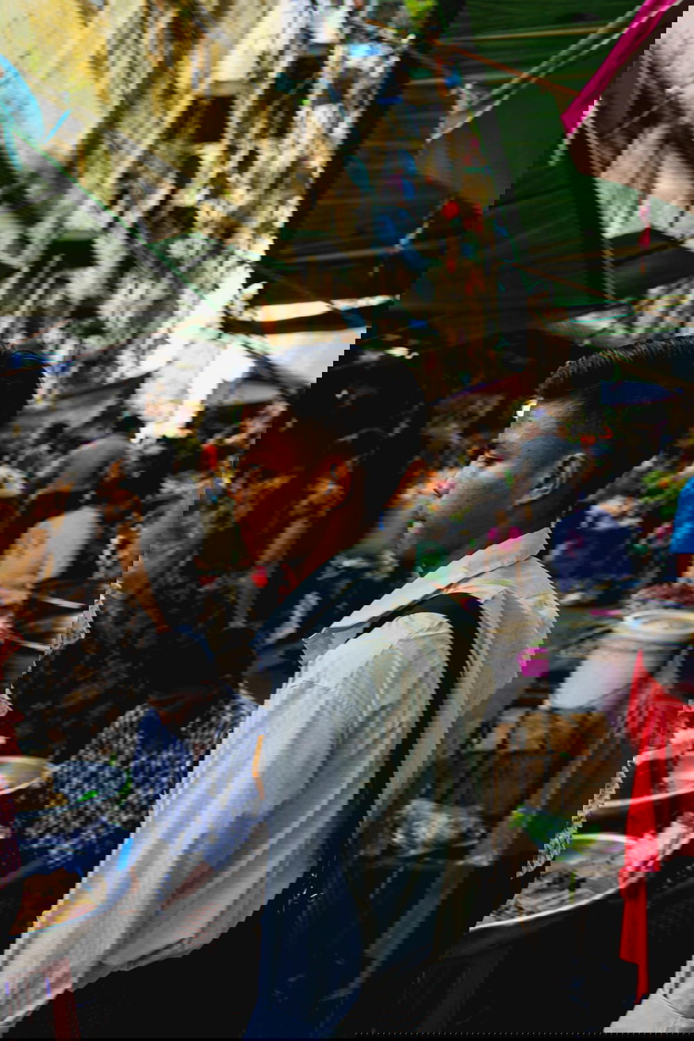 Burmese school boy in uniform crossing the street market of a busy road in Chinatown of Yangon Myanmar