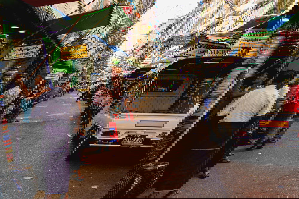 Working-class street scene in Chinatown of Yangon Myanmar where local Burmese people tend to their industrial shops