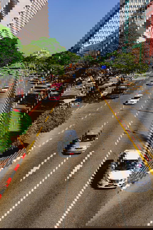 Cars are driving down the streets of Yangon, Myanmar (Burma).