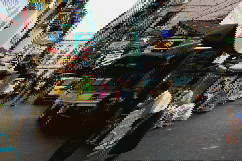 Burmese locals shopping on a commercial neighborhood street in downtown Yangon Myanmar