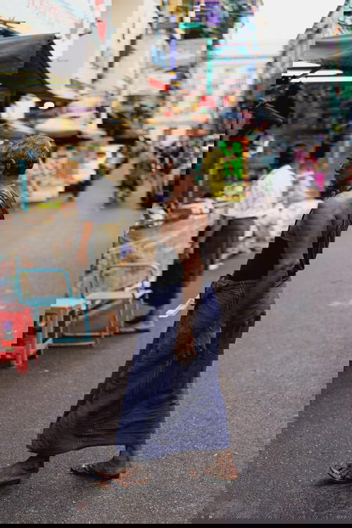 Man wearing longyi walking in Yangon, Myanmar