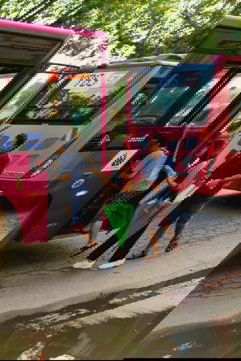Burmese locals board a public city bus in downtown Yangon Myanmar