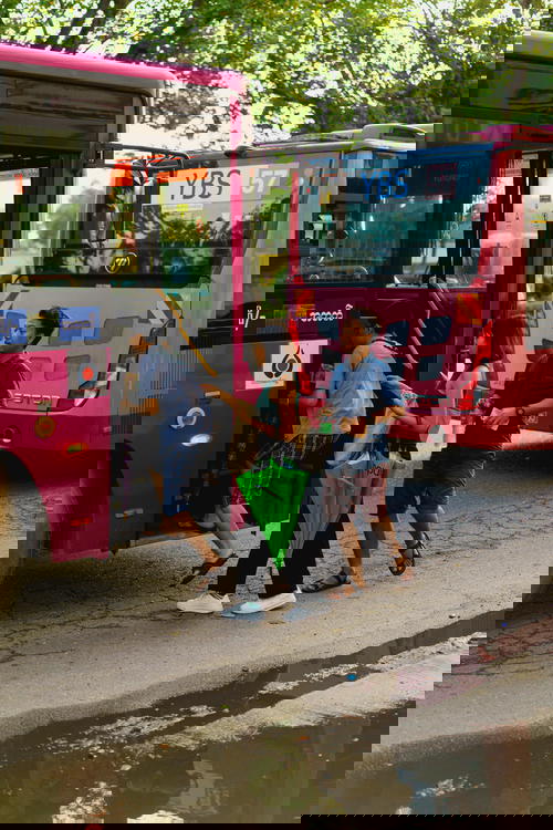 A group of people boarding a bus in Yangon, Myanmar (Burma).